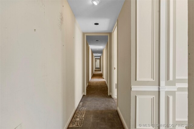 corridor featuring dark parquet flooring