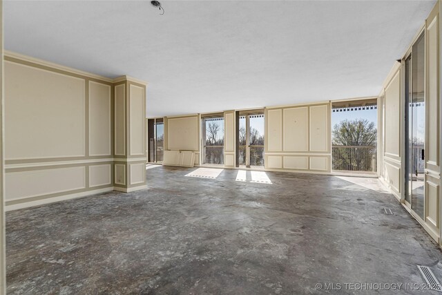 unfurnished living room with concrete flooring