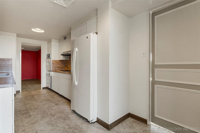 kitchen with white refrigerator with ice dispenser, white cabinets, oven, gas stovetop, and wall oven