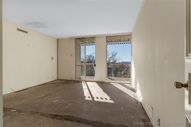 unfurnished room with floor to ceiling windows and crown molding