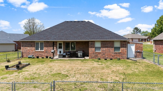 back of property featuring a patio and a lawn