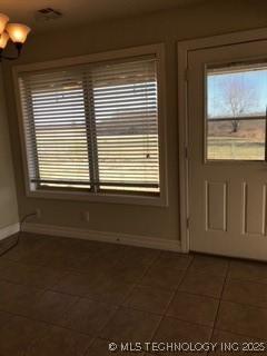 1704 Estates Dr, Grove, OK 74344 - doorway to outside featuring tile patterned flooring and baseboards