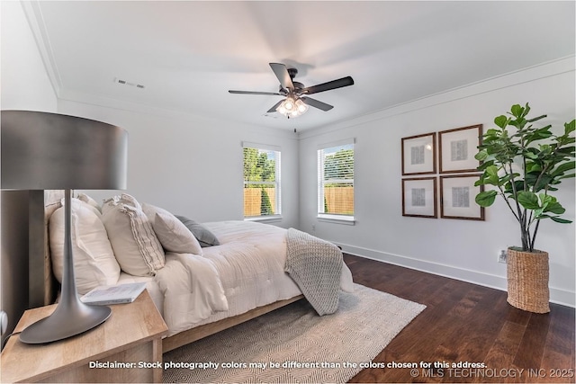 bedroom with baseboards, crown molding, visible vents, and dark wood-type flooring