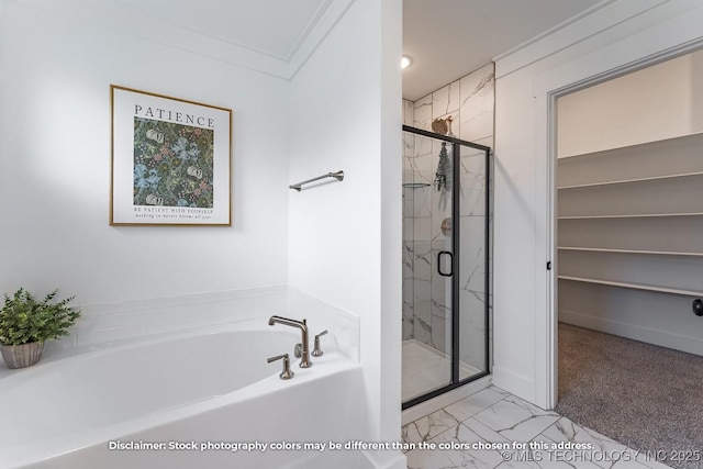 bathroom featuring a stall shower, baseboards, marble finish floor, a garden tub, and crown molding