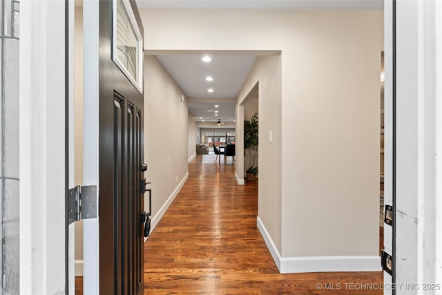 hall with dark wood-type flooring