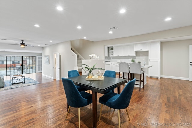 dining space featuring ceiling fan and dark hardwood / wood-style flooring