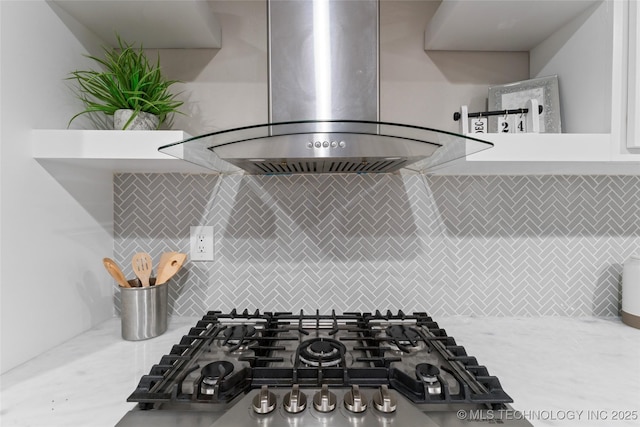 room details featuring backsplash, wall chimney exhaust hood, and gas cooktop