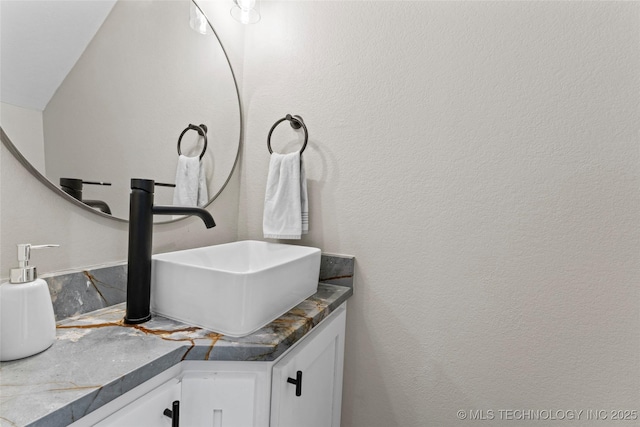 bathroom with vanity and vaulted ceiling