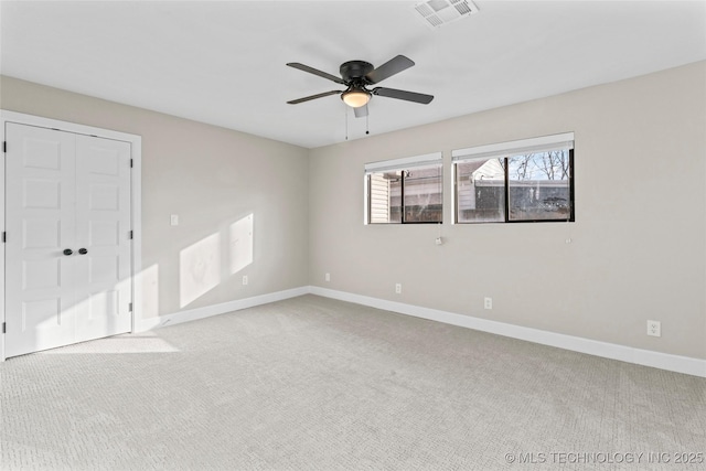 spare room with light carpet and ceiling fan