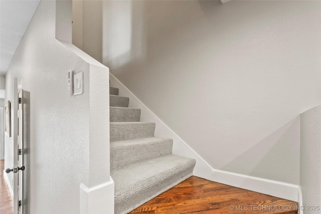 stairs featuring hardwood / wood-style flooring