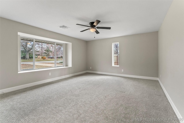 unfurnished room featuring carpet flooring, ceiling fan, and a healthy amount of sunlight