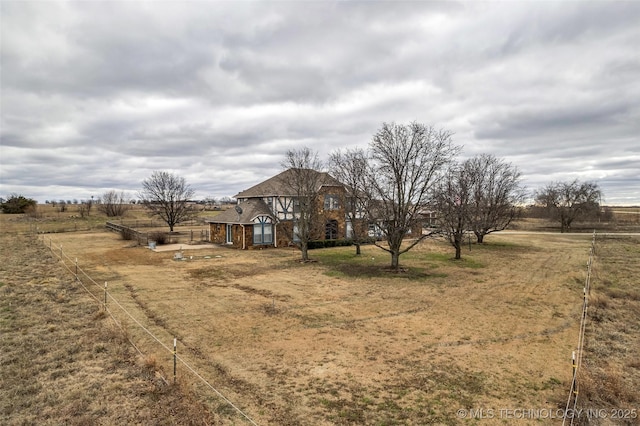 view of front of house with a rural view