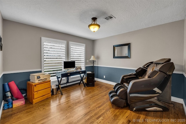 office with hardwood / wood-style flooring and a textured ceiling