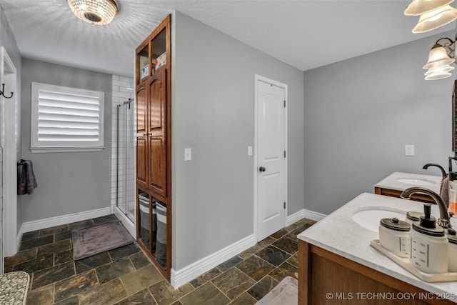 bathroom with vanity and a shower with door