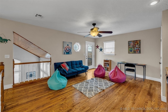 living room featuring light hardwood / wood-style flooring and ceiling fan