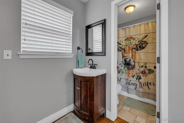 bathroom featuring a shower with curtain, tile patterned flooring, vanity, and toilet