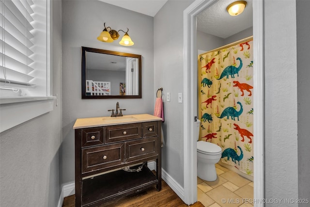 bathroom featuring a shower with curtain, vanity, and toilet