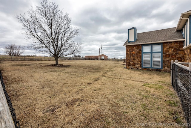 view of yard with a rural view