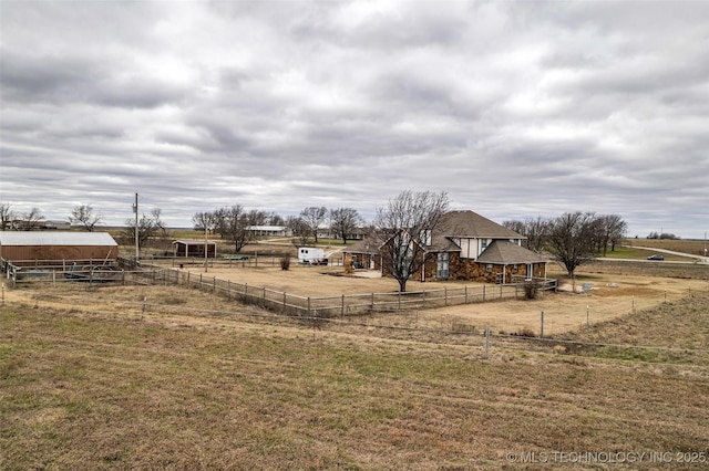 view of yard with a rural view and an outdoor structure