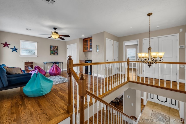 7033 S 4130th Rd, Talala, OK 74080 - interior space featuring a chandelier, a ceiling fan, baseboards, and wood finished floors