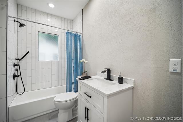 full bathroom with vanity, toilet, and shower / bathtub combination with curtain