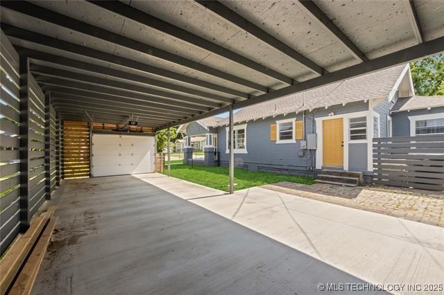 exterior space with a garage and a carport