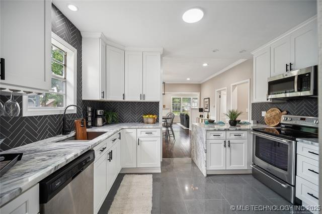 kitchen with white cabinets, stainless steel appliances, and sink