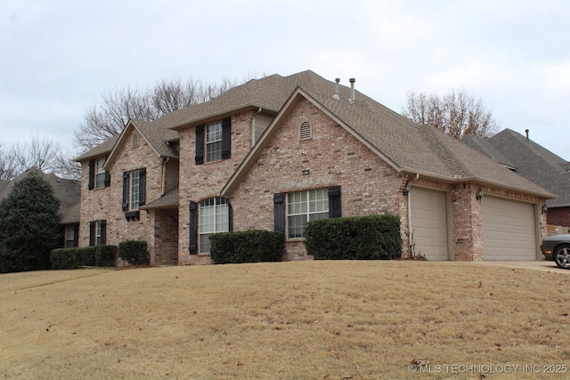 front of property featuring a garage and a front lawn