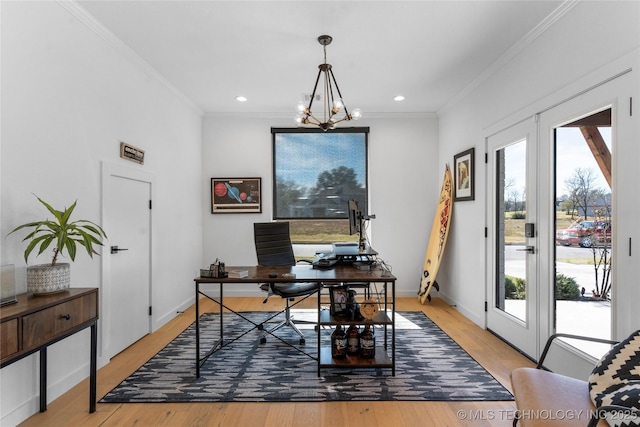 office area featuring light hardwood / wood-style flooring, crown molding, and a notable chandelier