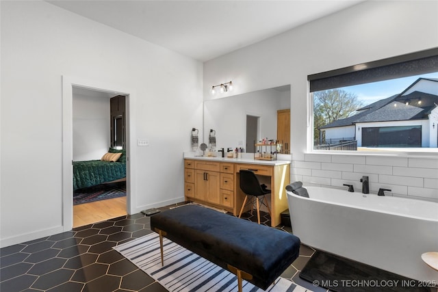 bathroom with a tub and vanity