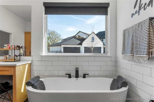 bathroom featuring a tub and plenty of natural light