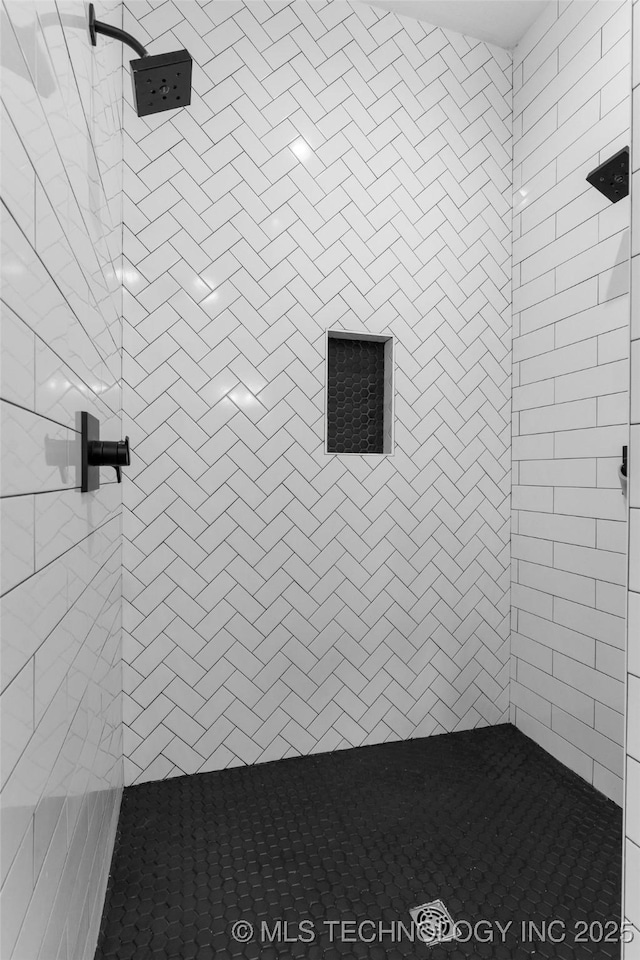 bathroom with tiled shower