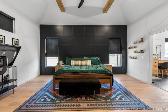 bedroom featuring lofted ceiling with beams, light hardwood / wood-style floors, and ceiling fan