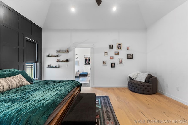 bedroom with light hardwood / wood-style flooring and lofted ceiling