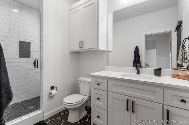 bathroom featuring baseboards, toilet, tile patterned flooring, vanity, and a shower stall