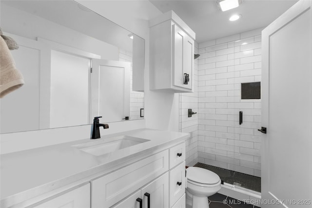 bathroom with vanity, a shower with shower door, and toilet