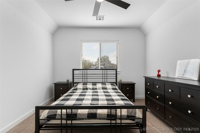 carpeted bedroom with ceiling fan and vaulted ceiling