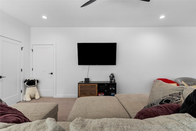 carpeted living room with ceiling fan