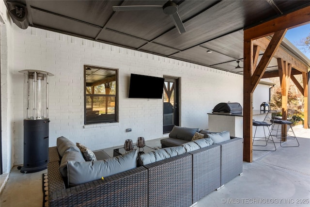 view of patio / terrace featuring exterior bar, an outdoor kitchen, an outdoor hangout area, and ceiling fan