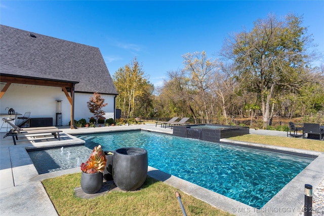 view of swimming pool with a patio area, an in ground hot tub, and pool water feature