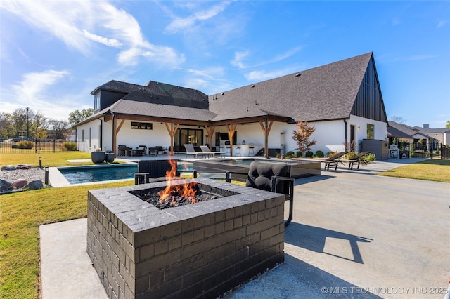 view of patio featuring a fenced in pool and an outdoor fire pit