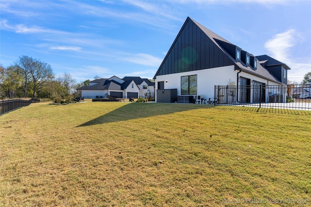 back of property with a lawn and central AC