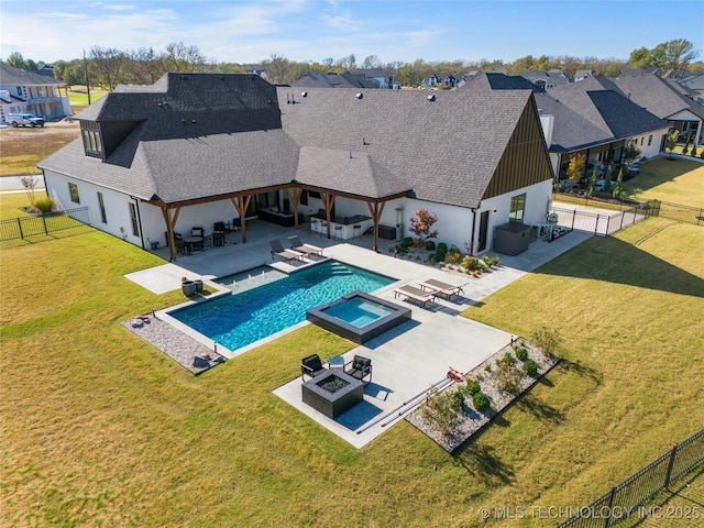 view of pool featuring a patio area, an in ground hot tub, a yard, and an outdoor living space with a fire pit