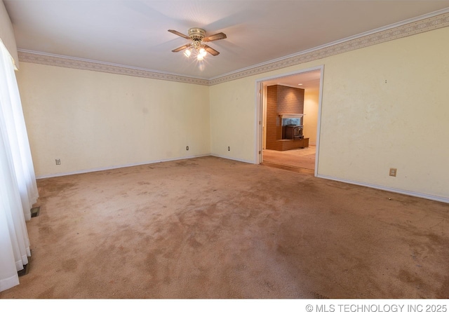 carpeted spare room featuring ceiling fan