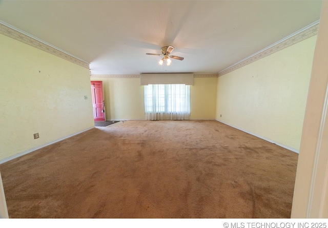 empty room featuring carpet flooring, crown molding, and ceiling fan