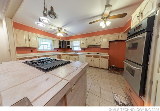 kitchen with white appliances, ceiling fan, sink, tile countertops, and light tile patterned flooring