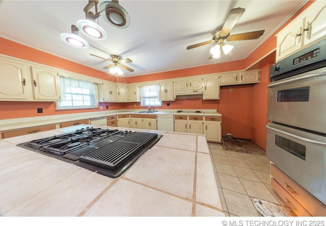 kitchen featuring white dishwasher, gas stovetop, double oven, sink, and tile countertops