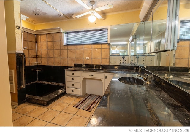 bathroom featuring a textured ceiling, ceiling fan, and sink