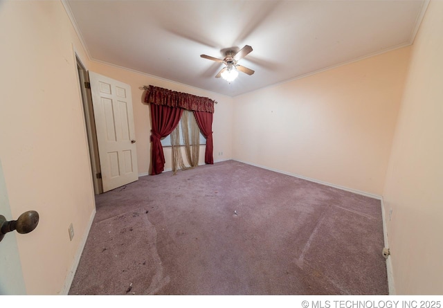 unfurnished room with carpet flooring, ceiling fan, and ornamental molding