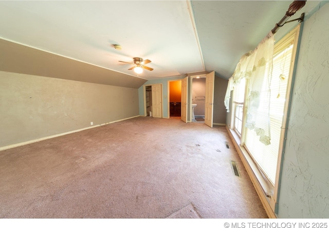 interior space with light carpet, ceiling fan, and lofted ceiling